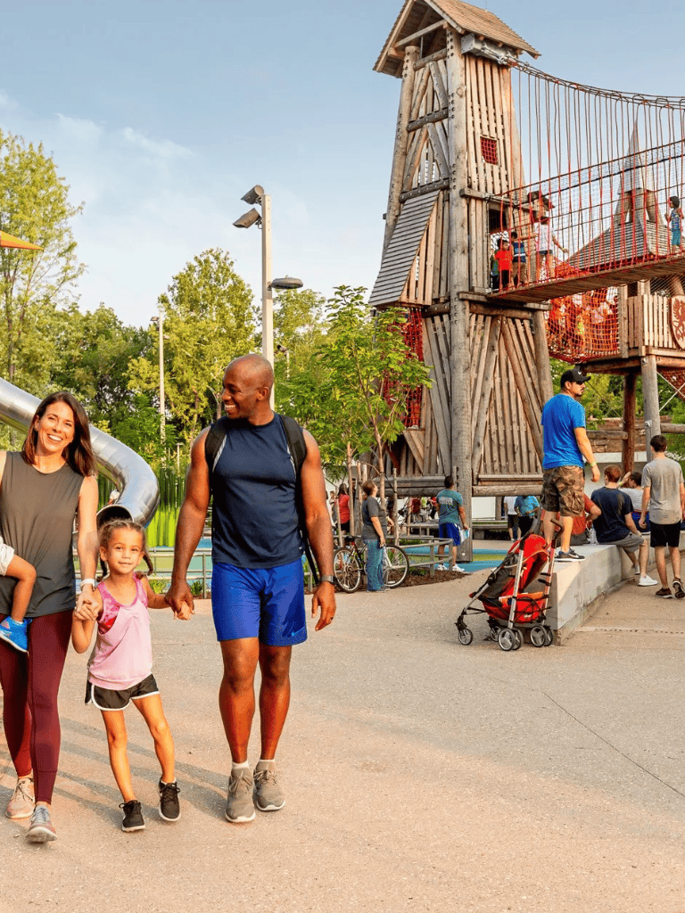 Climbing playground at Quest for Directions amusement park with families.