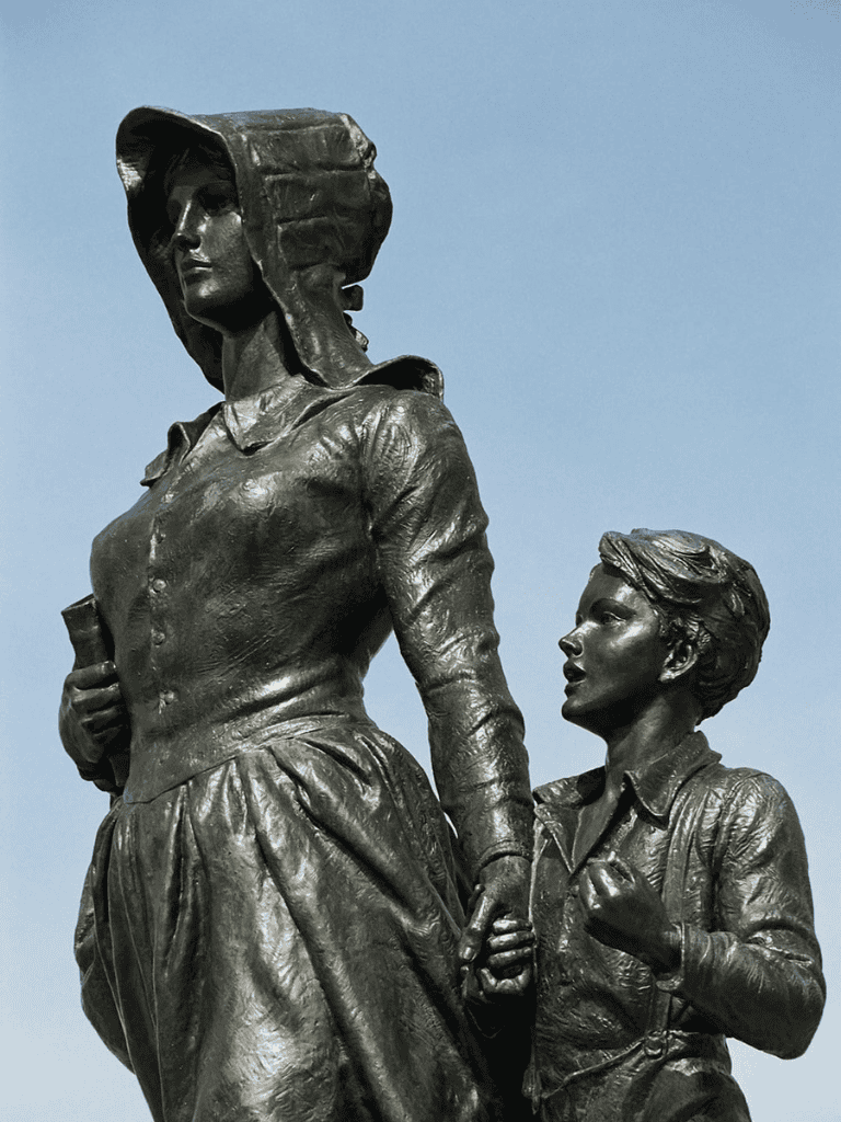 Empowering women and children bronze statue symbolizing strength, unity, and hope at QuestForDirections.