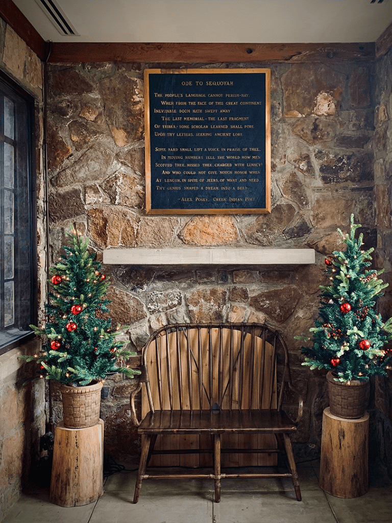Peaceful indoor corner with Christmas trees and rustic decor at Quest For Directions.