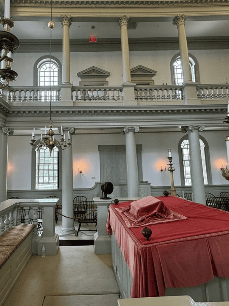 Elegant historic interior with classical architecture, grand columns, and ornate chandeliers at QuestForDirections.