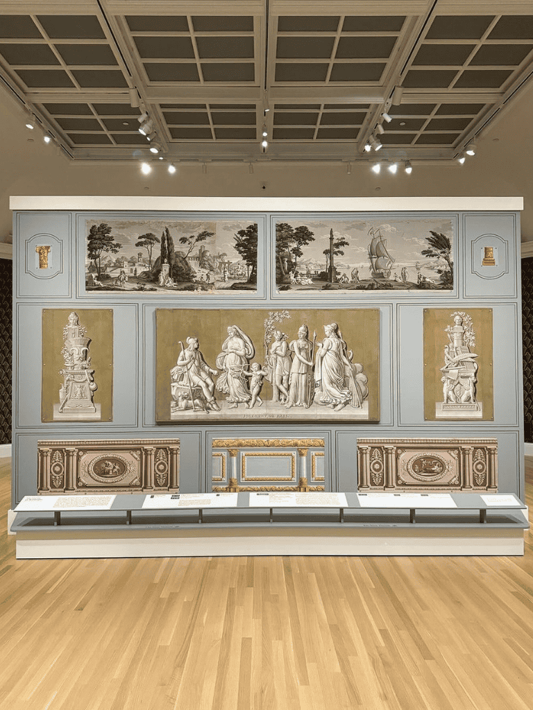Intricate classical art display with sculptures and murals in a museum setting.