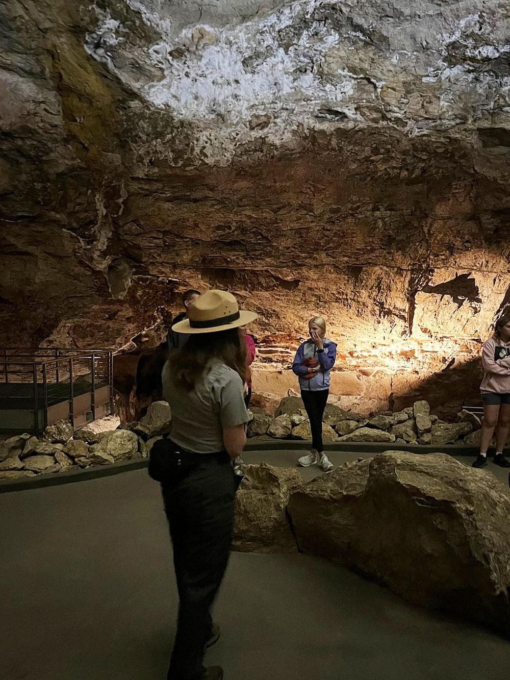 Cave tour with visitors exploring geological formations and natural stalactites at Quest for Directions.
