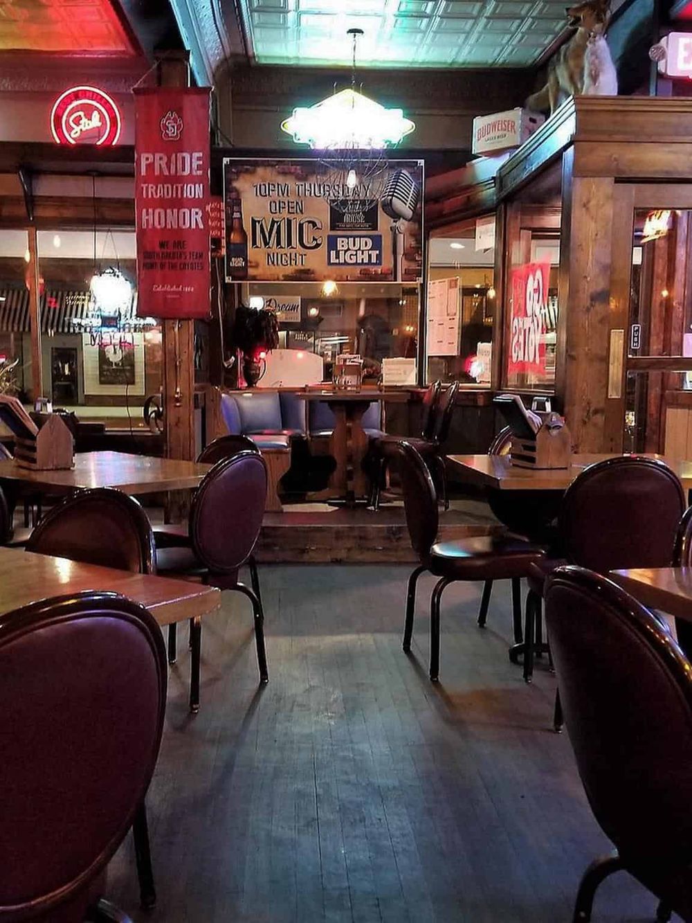 Cozy bar interior with wooden accents and lively atmosphere at QuestForDirections, perfect for drinks and live music.