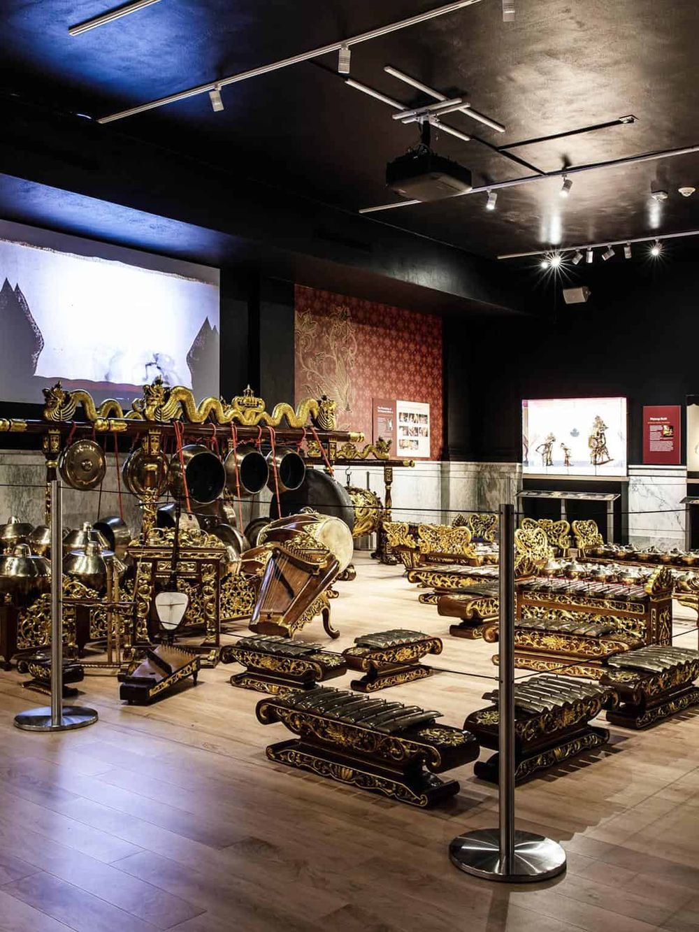 Intricate traditional Indonesian gamelan instruments displayed in a museum exhibit.