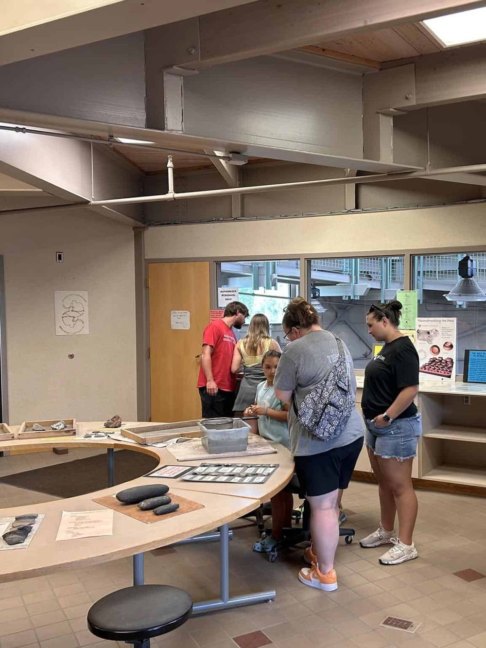 Children's hands-on archaeology exhibit at QuestForDirections, engaging kids in interactive learning about prehistoric tools.
