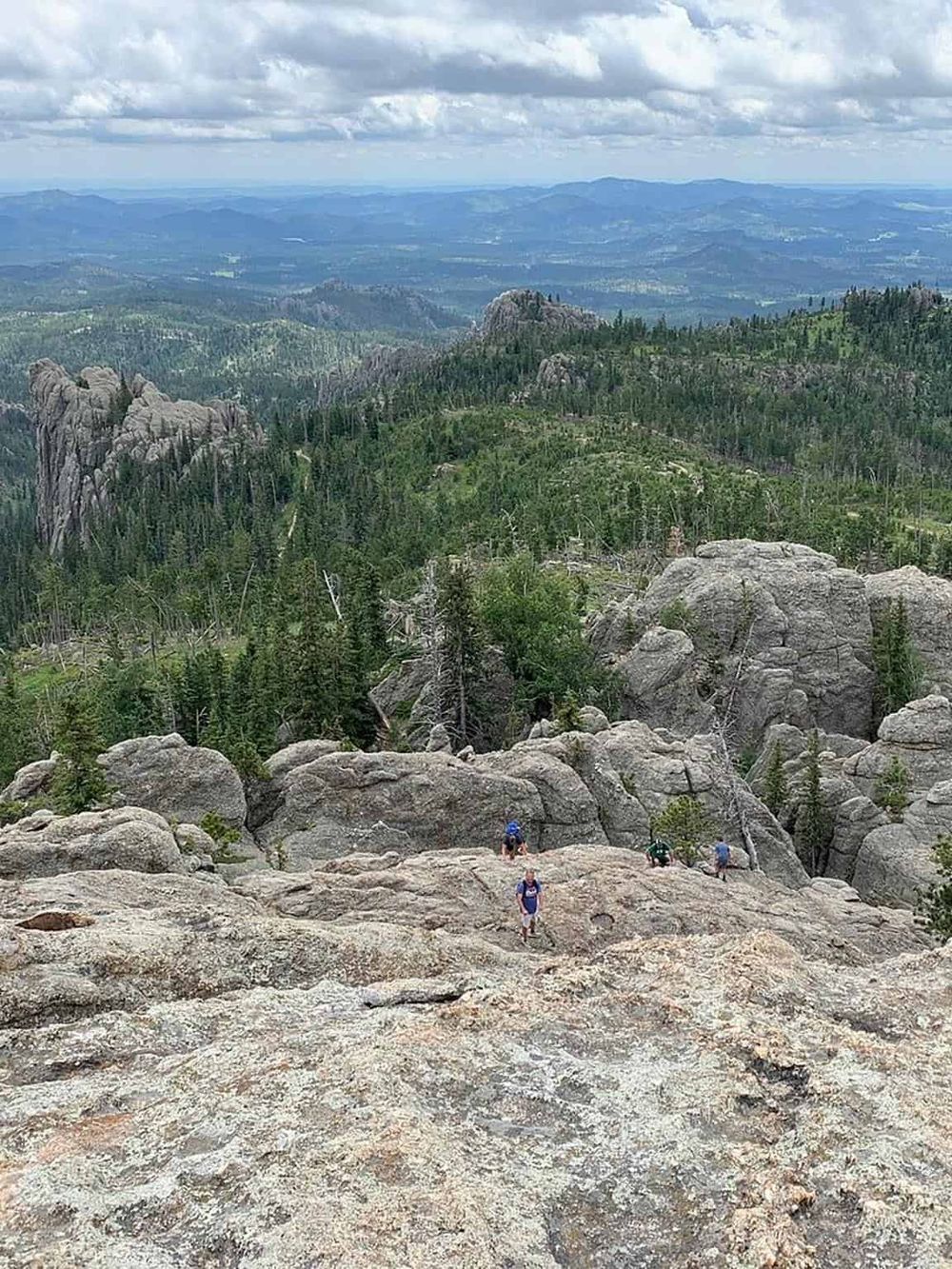 Breathtaking mountain landscape with rock formations and hikers enjoying nature exploration.