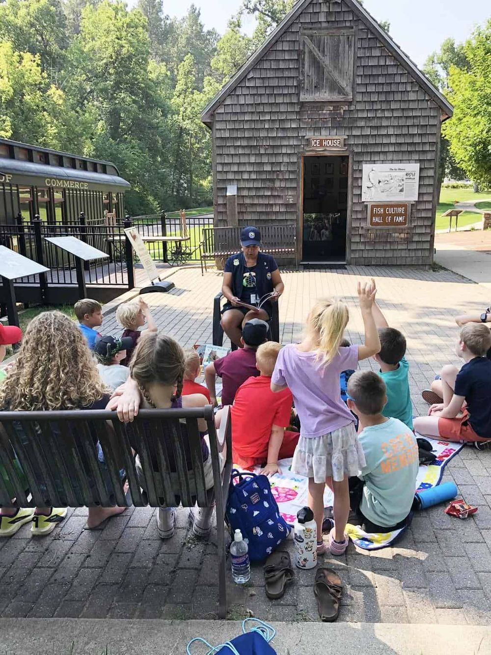 Kids outdoor educational program at QuestForDirections historic site, with guide and interactive storytelling.