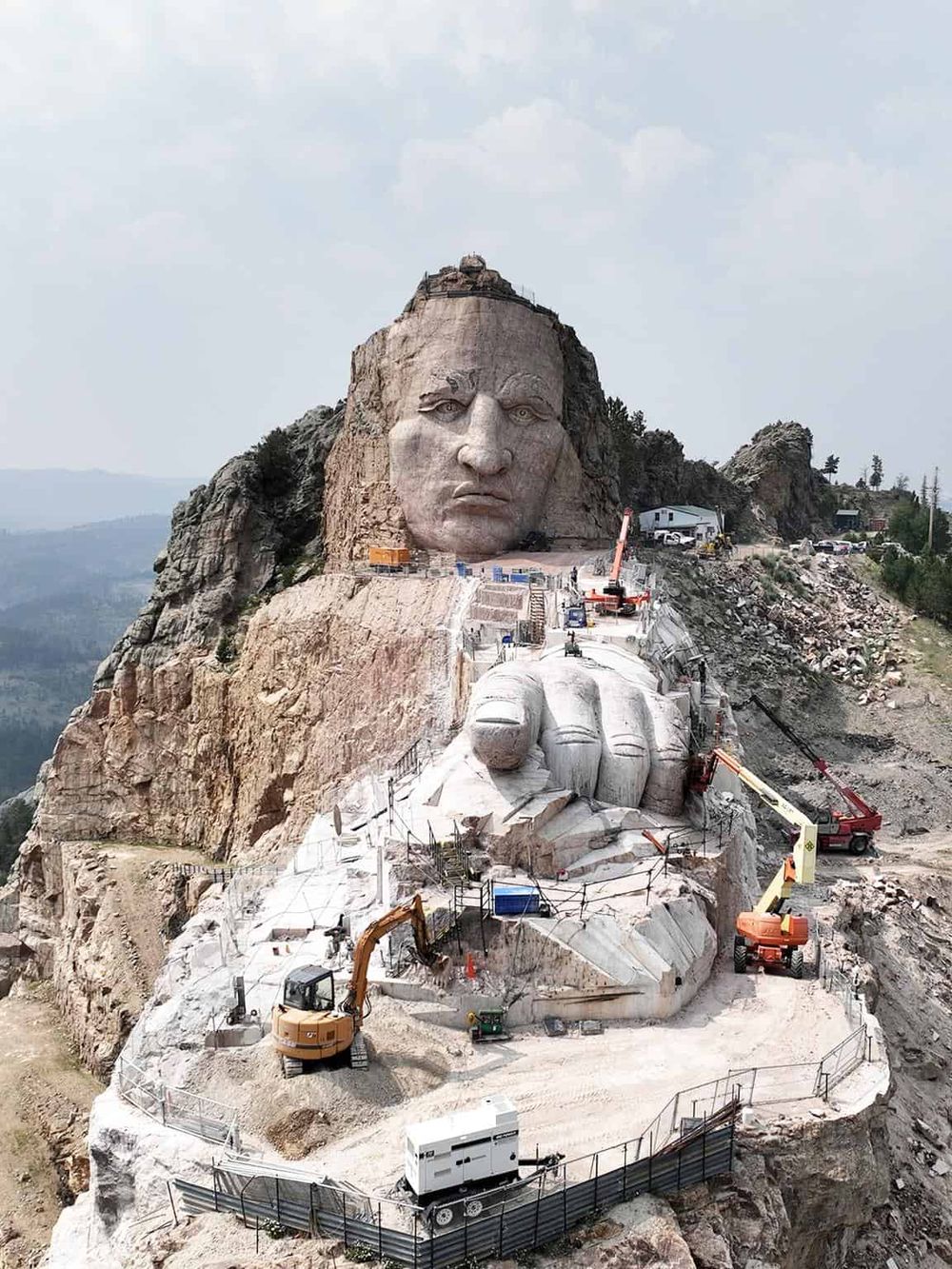 Intricate construction of Mount Rushmore with ongoing sculpting and machinery, showcasing the iconic American monument.