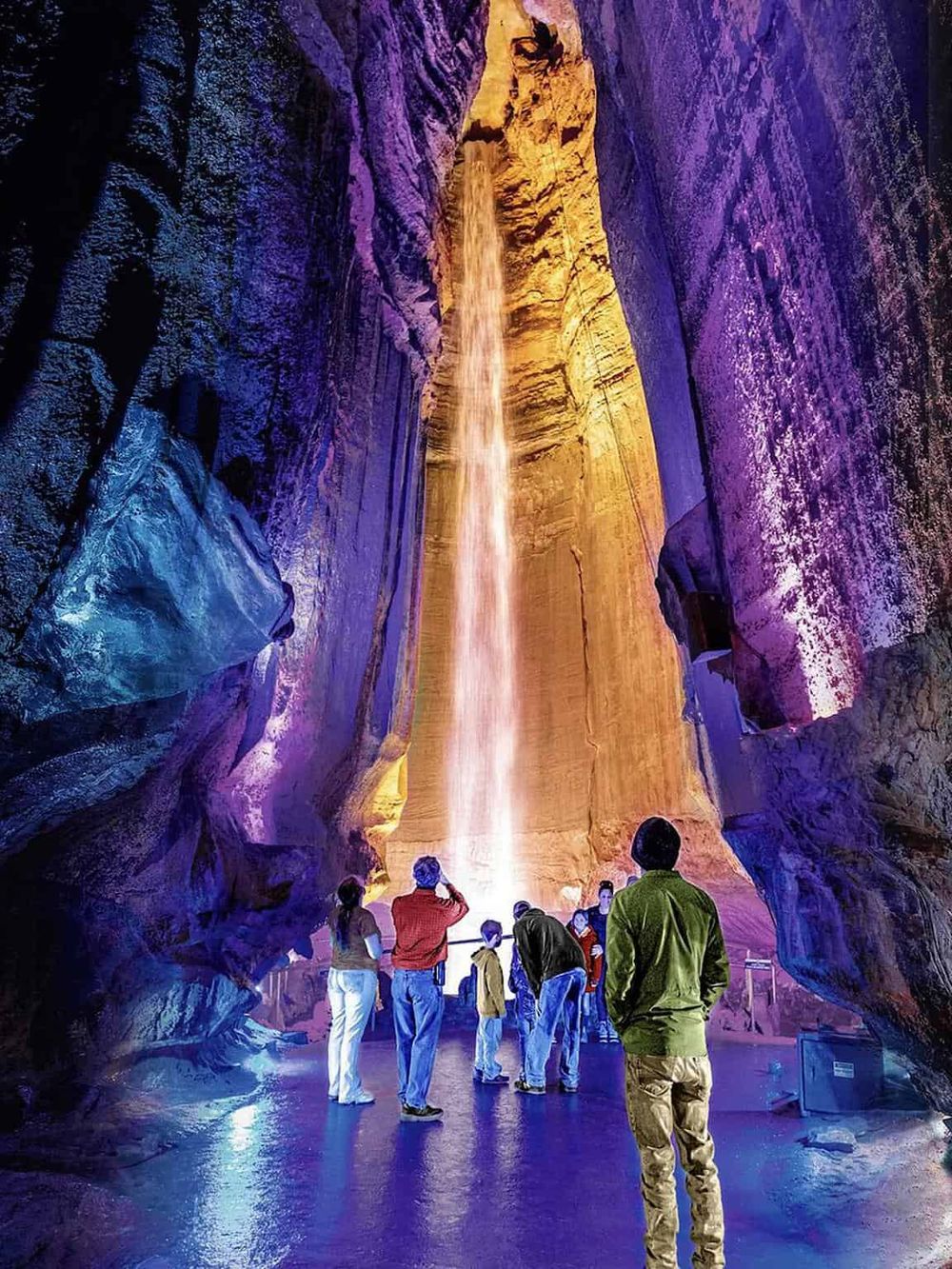 Colorful illuminated indoor canyon with waterfalls, popular tourist attraction and natural wonder.