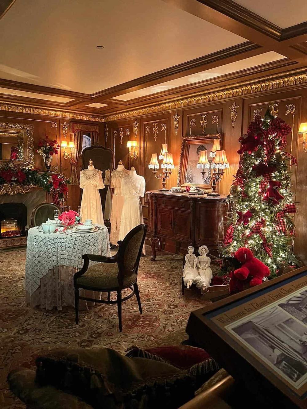Elegant vintage holiday scene with Christmas tree, dolls, and antique furniture in warm lighting.