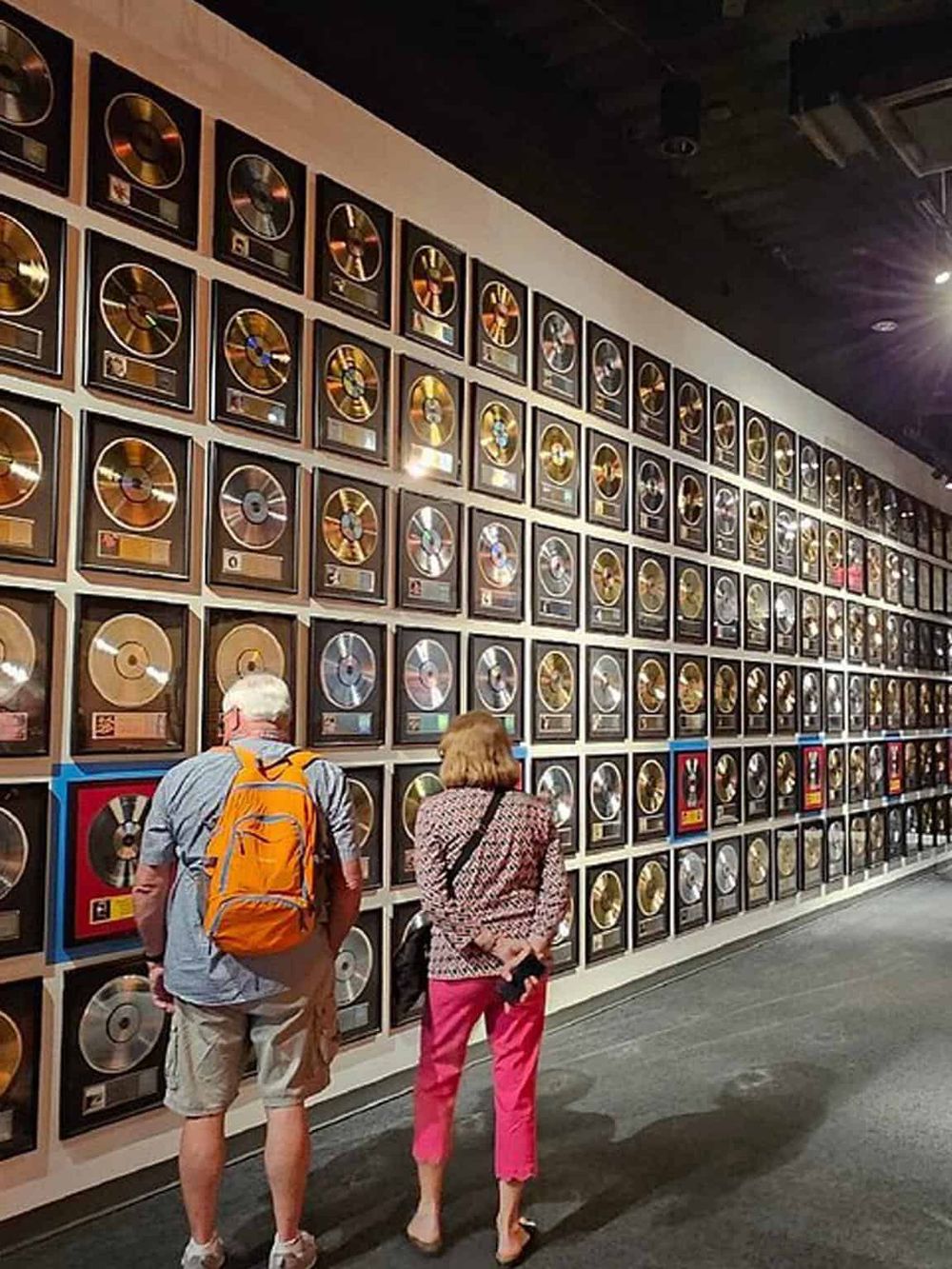 Gold record awards display at QuestForDirections music museum showcasing iconic music achievements and memorabilia.