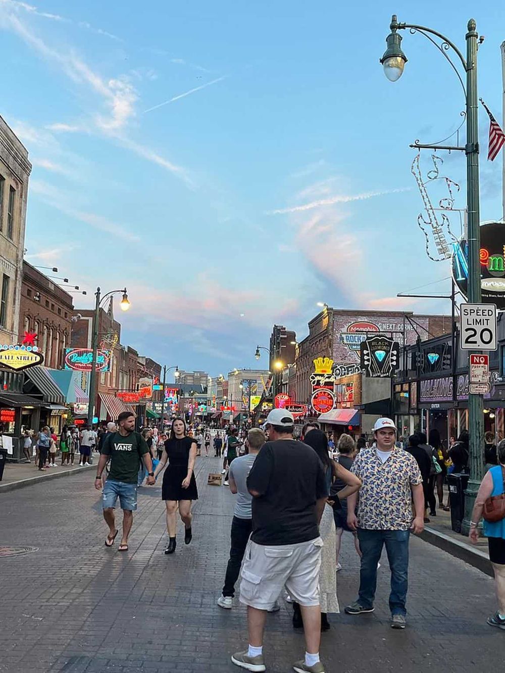 Vibrant street scene with people strolling through a lively downtown area, showcasing local attractions and vibrant nightlife.