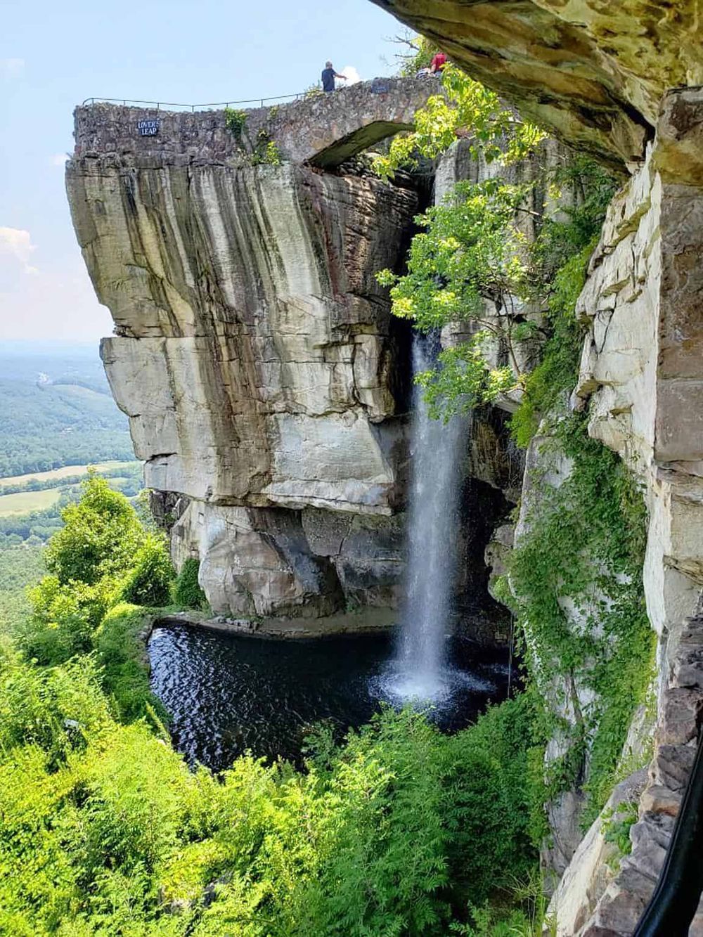 Breathtaking view of a waterfall and natural rock formations at Lands' Leap, a popular scenic spot in the mountains.