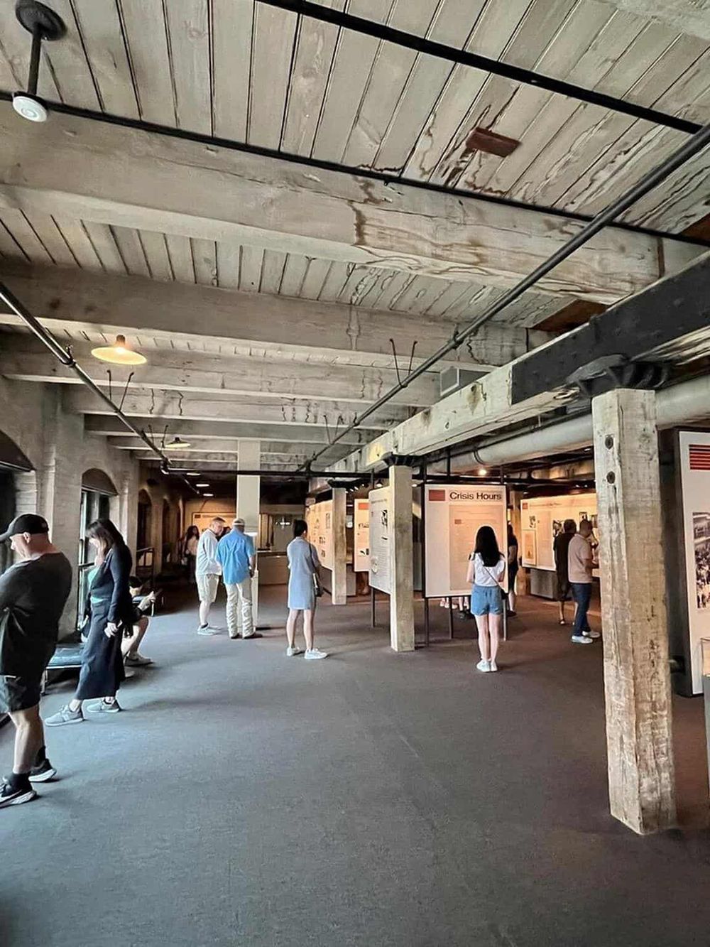 Historical exhibit space at QuestForDirections museum featuring informational displays and visitors.