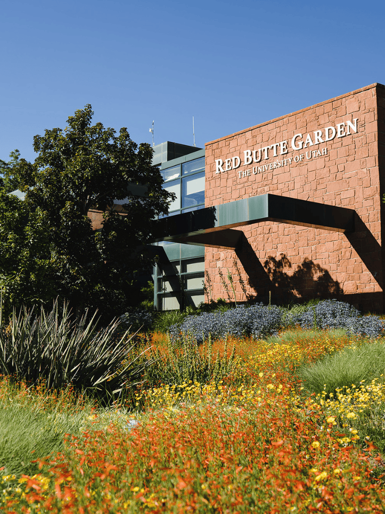 Lush garden outside Red Butte Garden at the University of Utah, featuring vibrant flowers and greenery.