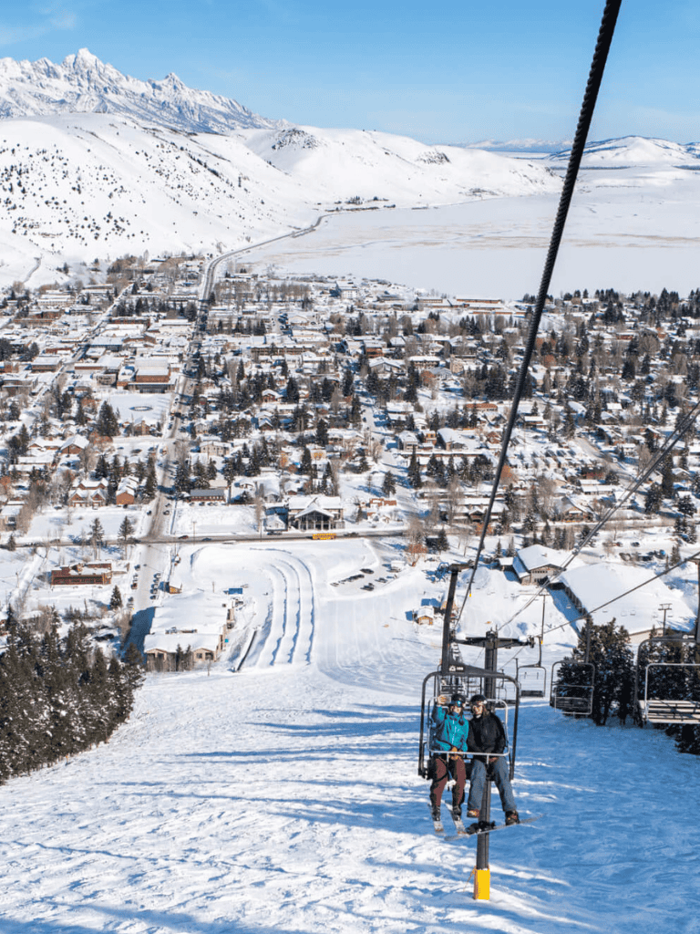 Snowy town and mountain landscape from ski lift, winter travel destination, QuestForDirections.