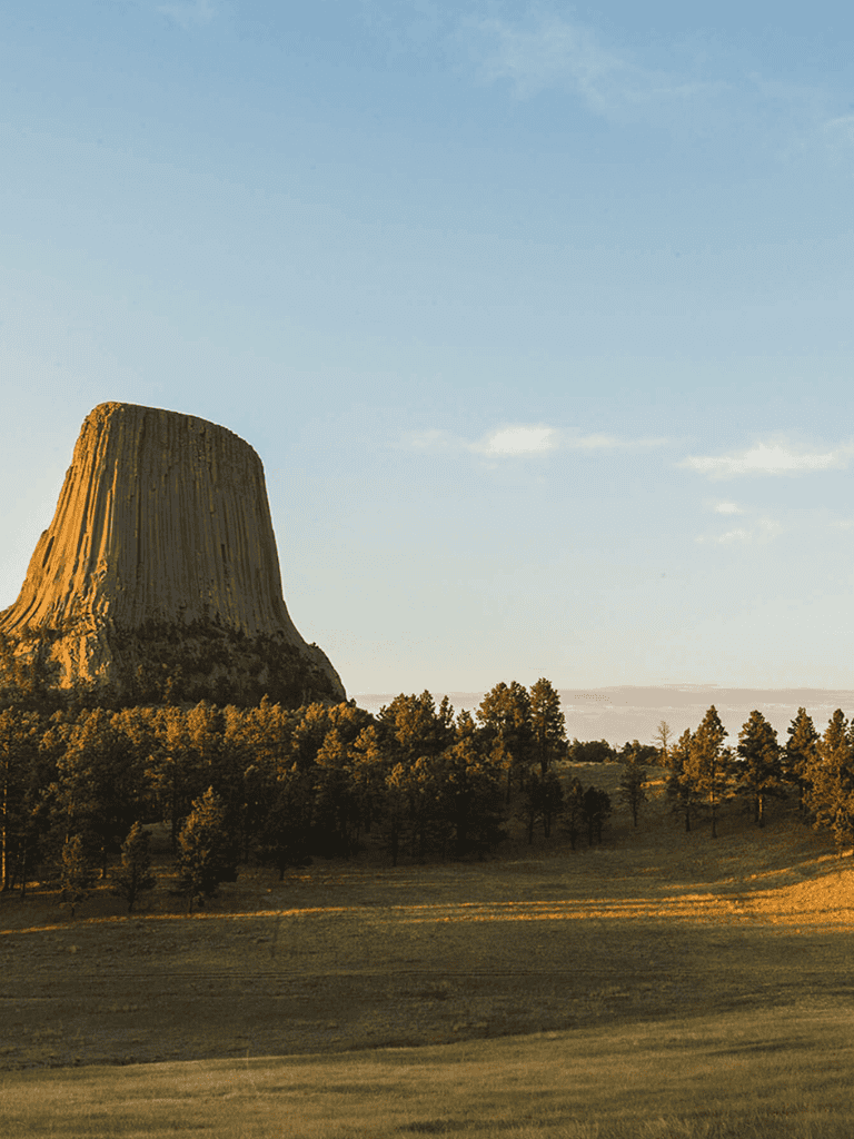 Majestic Devil's Tower in sunrise light, iconic symbol of American natural beauty.