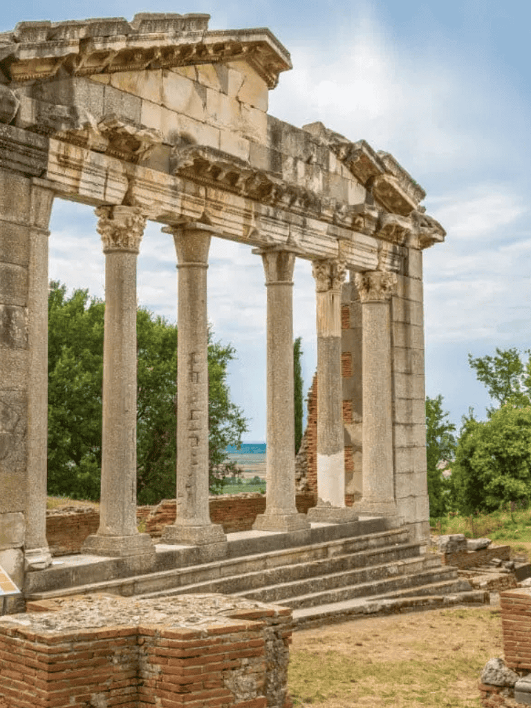 Ancient Greek ruins with columns and steps, historical site exploration, architecture, archaeological sightseeing, cultural heritage.