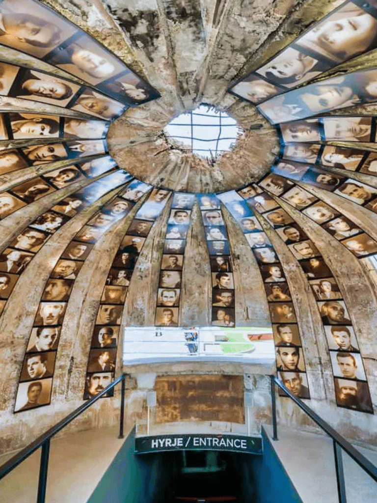 Portraits of resilient individuals inside the circular memorial at Quest for Directions, capturing history and inspiring visitors.