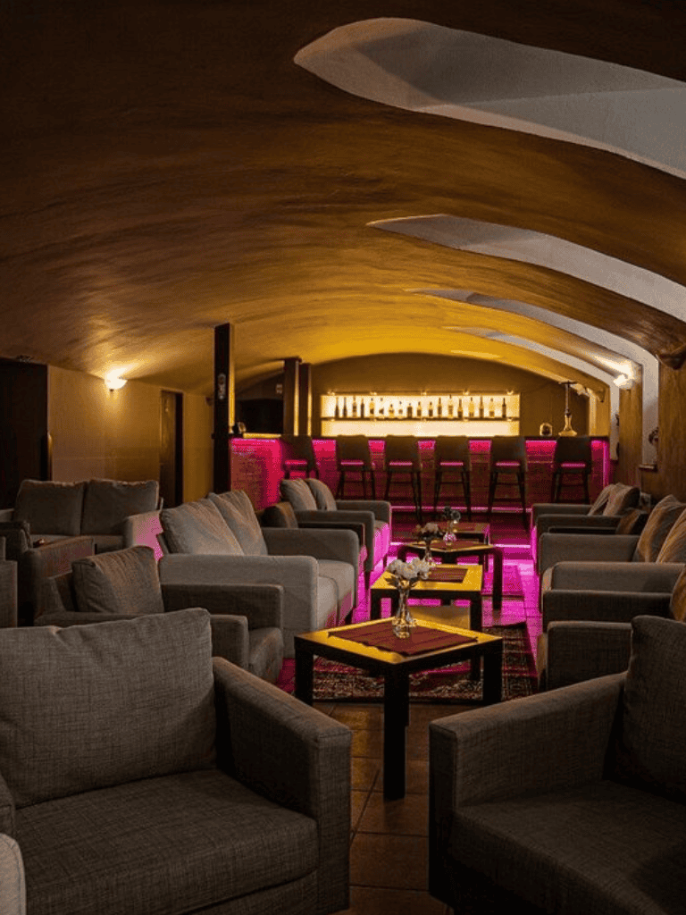 Cozy lounge with plush seating and ambient lighting at QuestForDirections bar and restaurant.