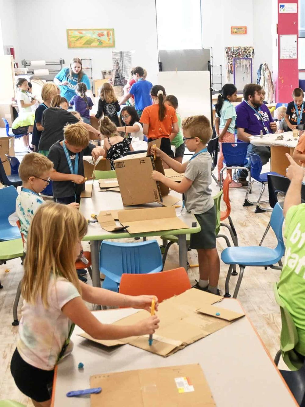 Children engaged in STEM activities at a youth coding and robotics workshop, fostering innovation and creativity.