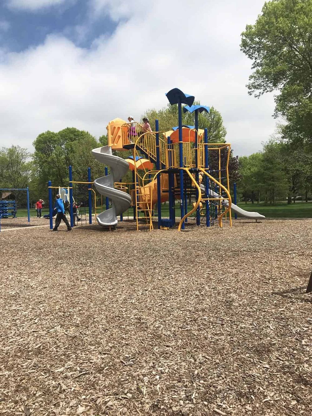 Colorful children's playground at QuestForDirections park in springtime.