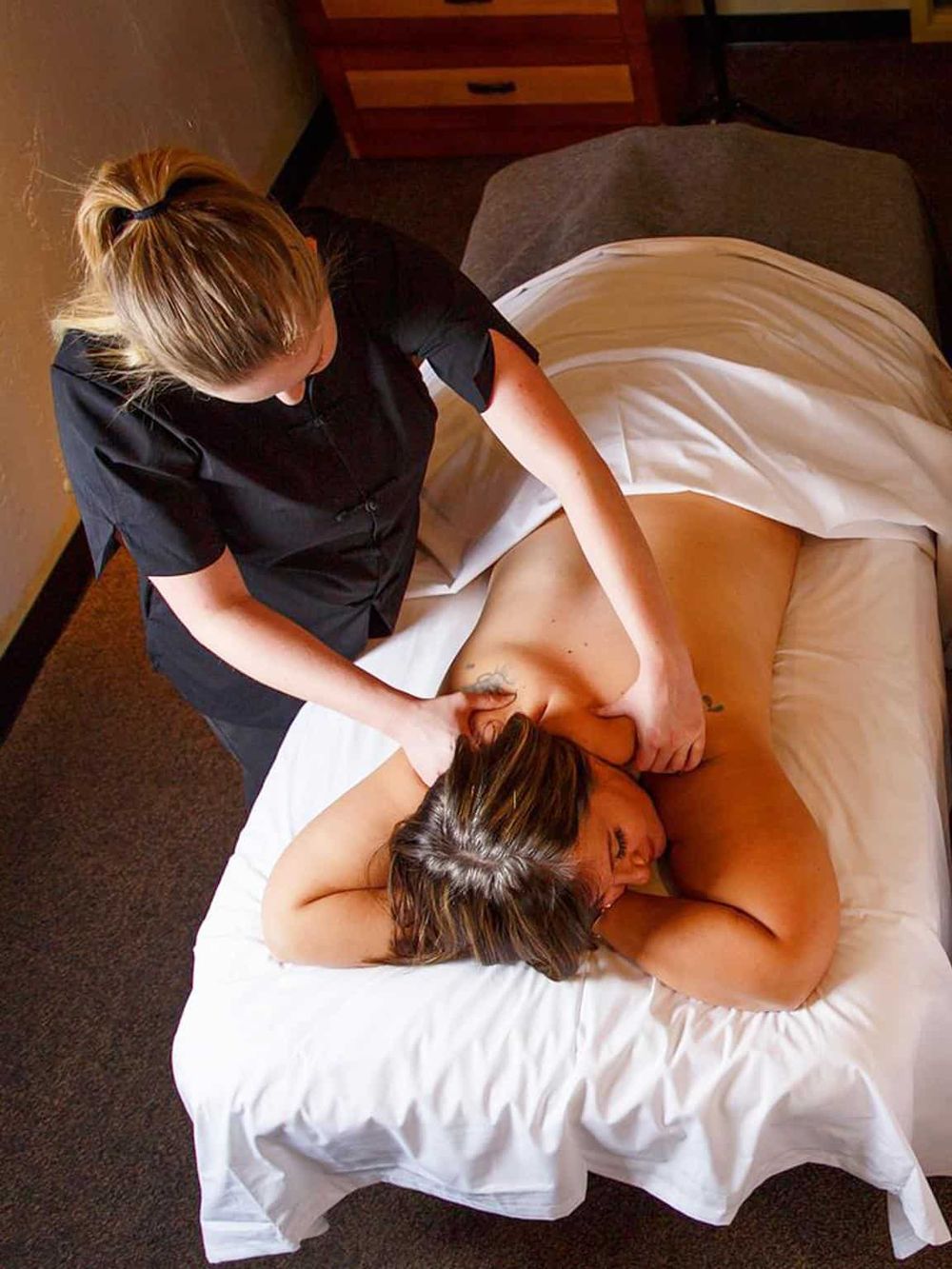 Relaxing massage therapy session at a spa, professional massage therapist providing soothing body massage.