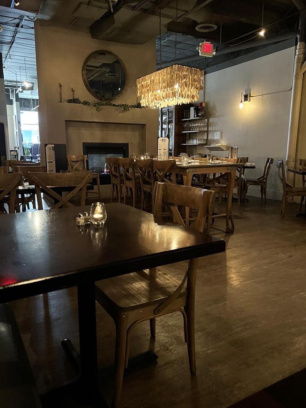 Cozy restaurant interior with wooden furniture and warm lighting, perfect for a dining experience in a modern, stylish setting.