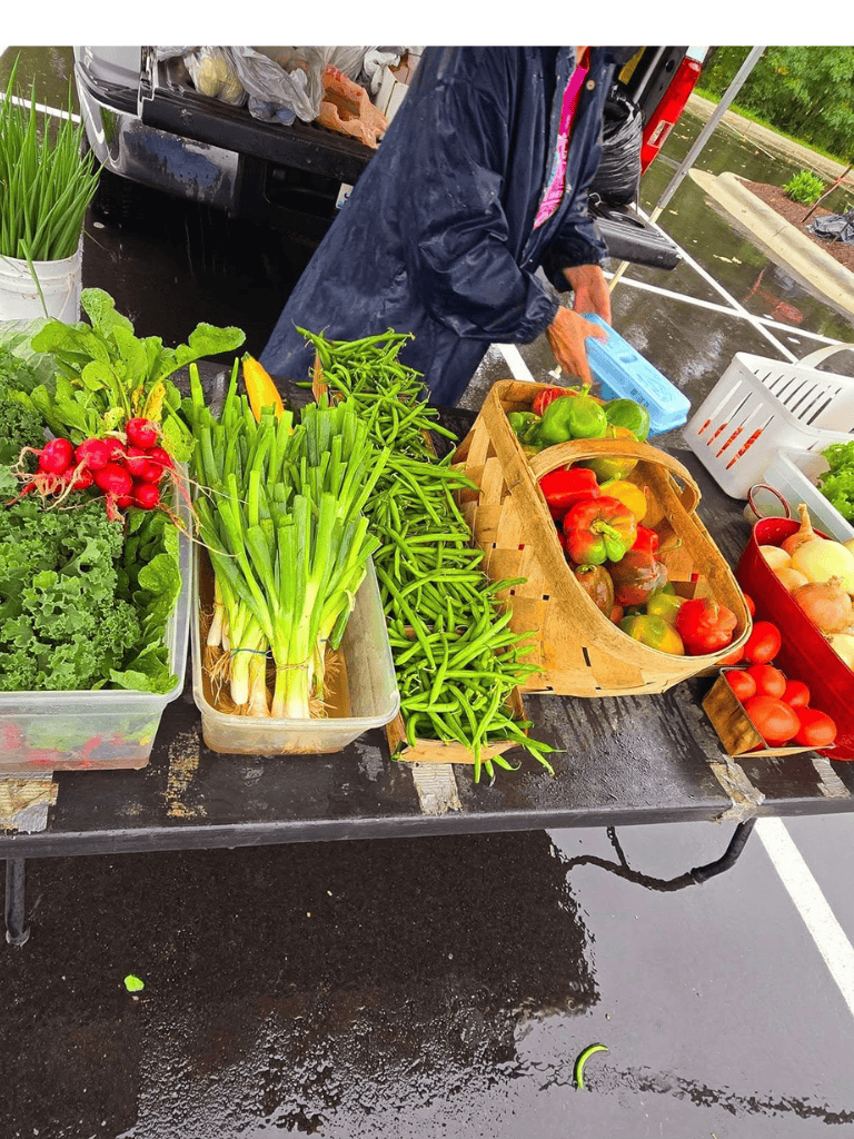 Fresh farm vegetables at a farmers market stall, showcasing a variety of colorful produce for healthy eating.