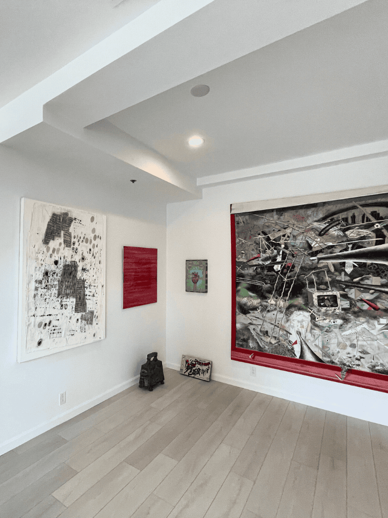 Contemporary art gallery showcasing modern abstract paintings and mixed media art pieces.
