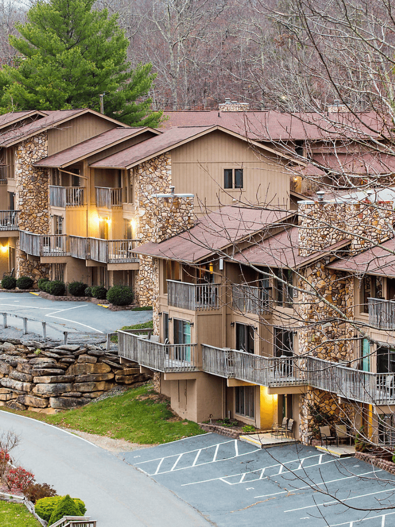 Charming mountain lodge apartments with private balconies and scenic wooded views.
