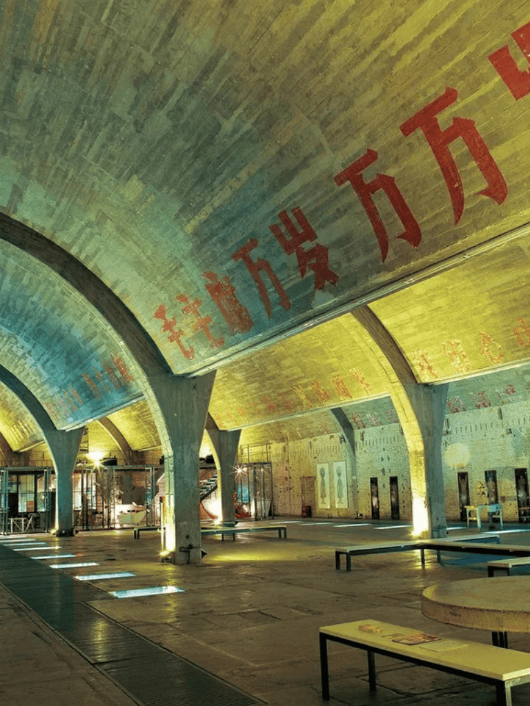 Colorful underground tunnel with Chinese characters, modern lighting, and seating areas.
