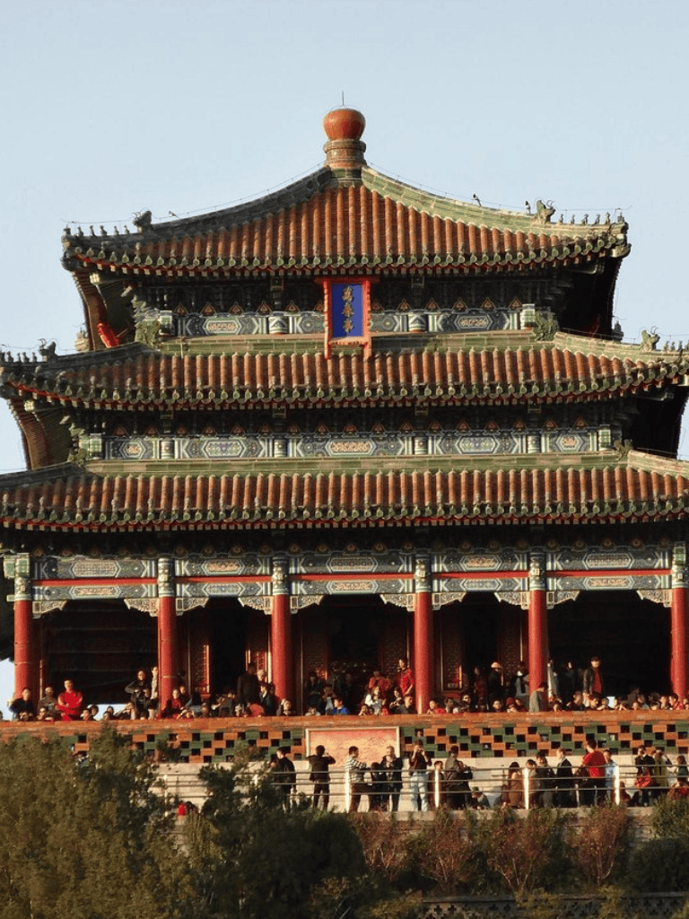 Ancient Chinese temple with ornate roof and visitors, cultural heritage site, traditional architecture.
