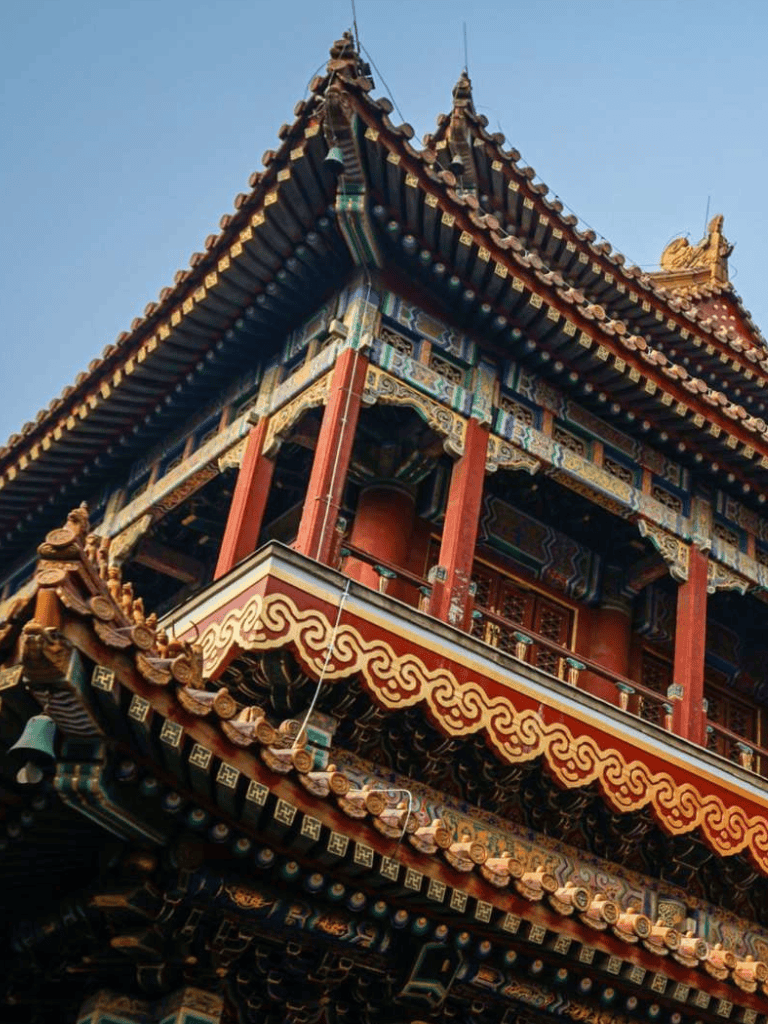 Intricate traditional Chinese temple rooftop with colorful detailed carvings and vibrant colors.