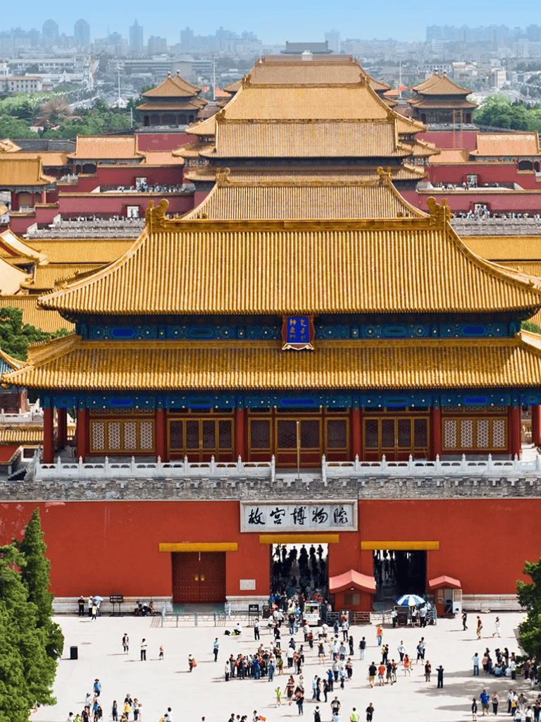 Ancient Chinese imperial palace with traditional architecture and visitors exploring the historic site.
