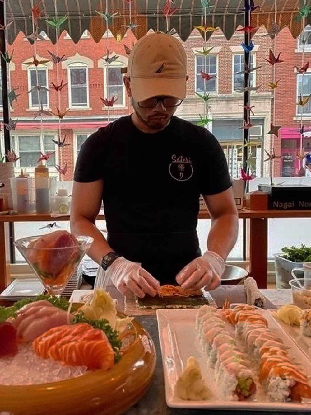 Fresh sushi chef preparing sushi at a Japanese restaurant, showcasing authentic sushi making and seafood delicacies.