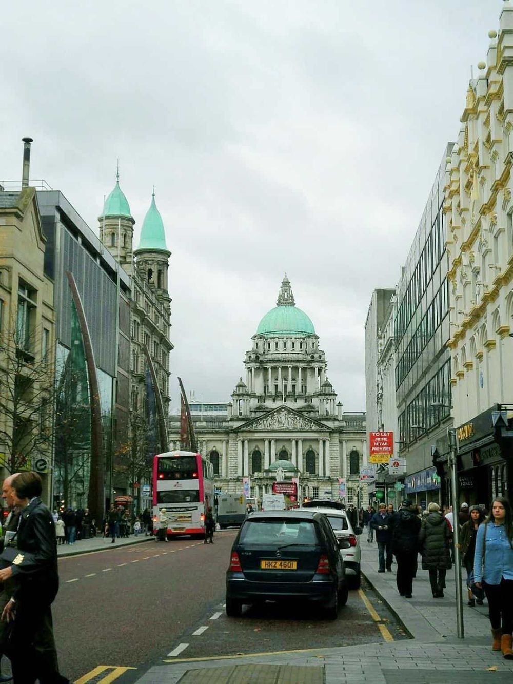 Elegant city street view showcasing historic architecture and bustling urban life in front of St. Paul's Cathedral in London.
