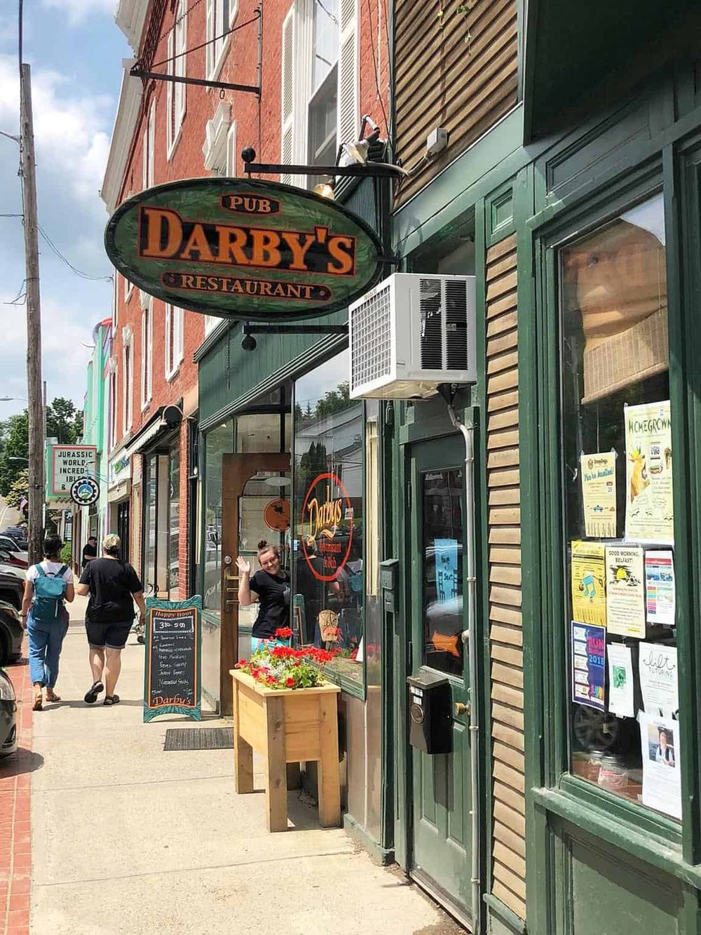 Cozy pub and restaurant exterior in a vibrant downtown, welcoming locals to enjoy casual dining and drinks.