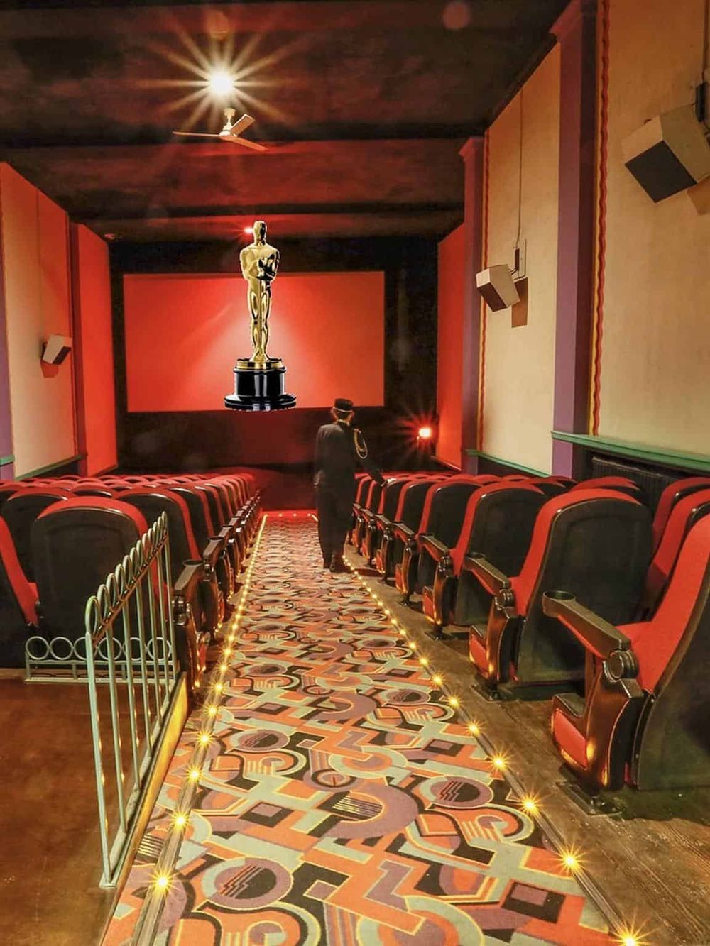 Golden Oscar statue on stage at movie award ceremony.