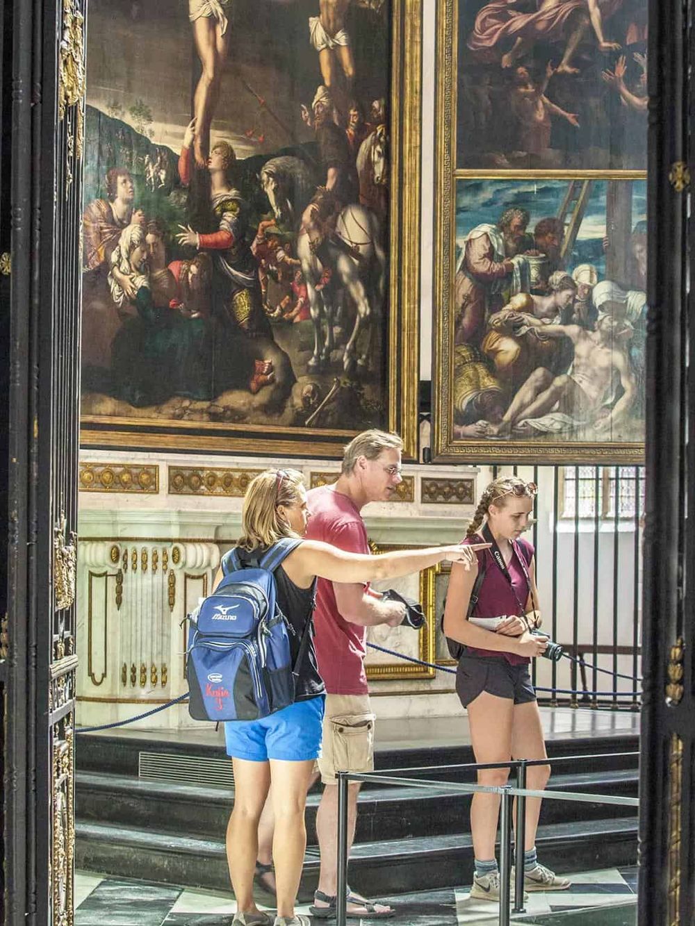 Vivid artwork display at QuestForDirections museum featuring visitors admiring classical paintings.