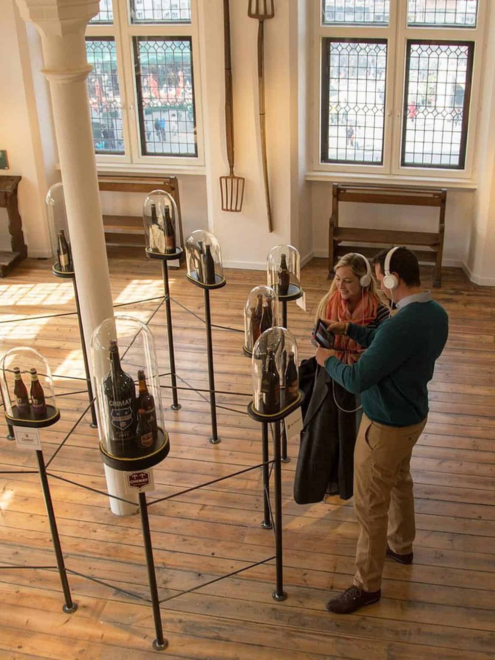 Vintage beer exhibit at a museum showcasing historical beer bottles and containers.
