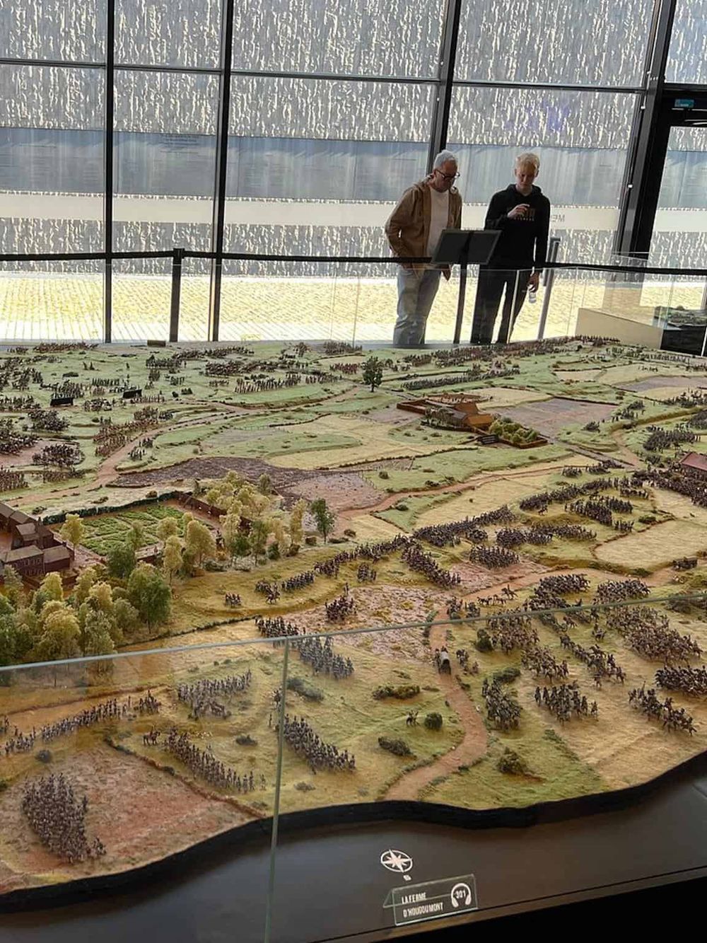 Miniature historical battlefield model at QuestForDirections exhibit, showcasing historical insights and directions.