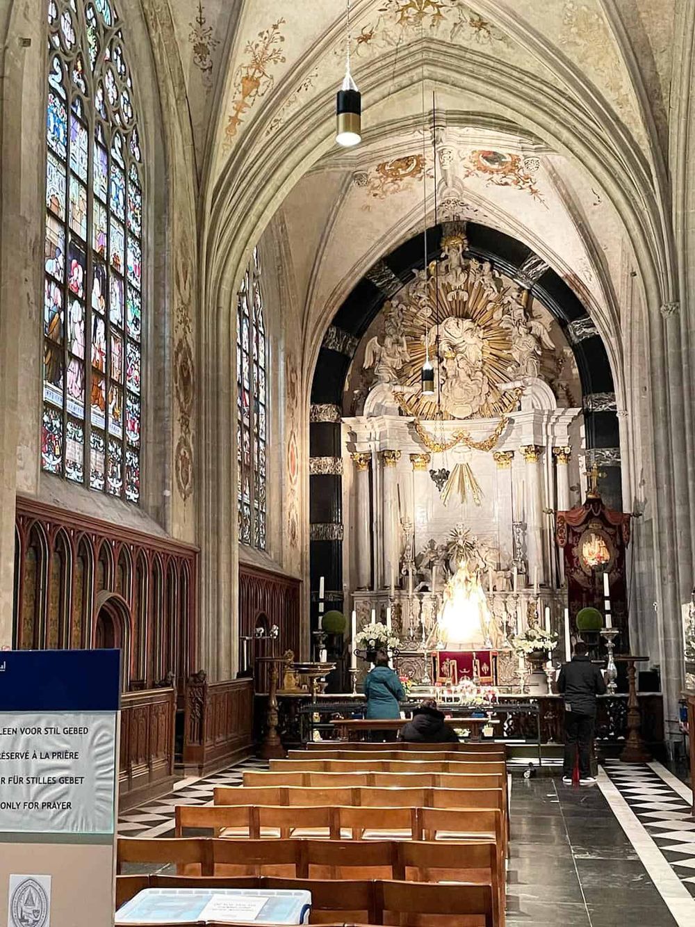 Intricate church interior with stained glass windows, ornate altar, and Gothic arches for spiritual guidance.