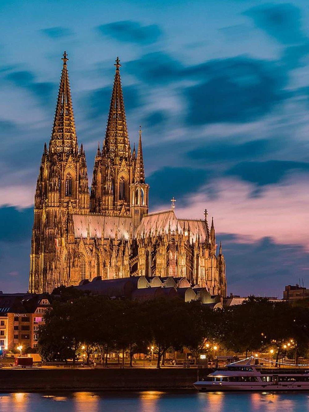 Majestic Gothic cathedral illuminated at dusk, showcasing QuestForDirections travel and navigation expertise.