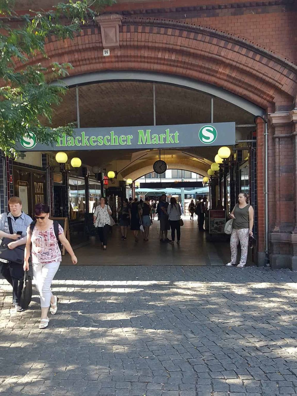 Colorful entrance of Hackescher Markt in Berlin, popular public transport hub and vibrant shopping district.