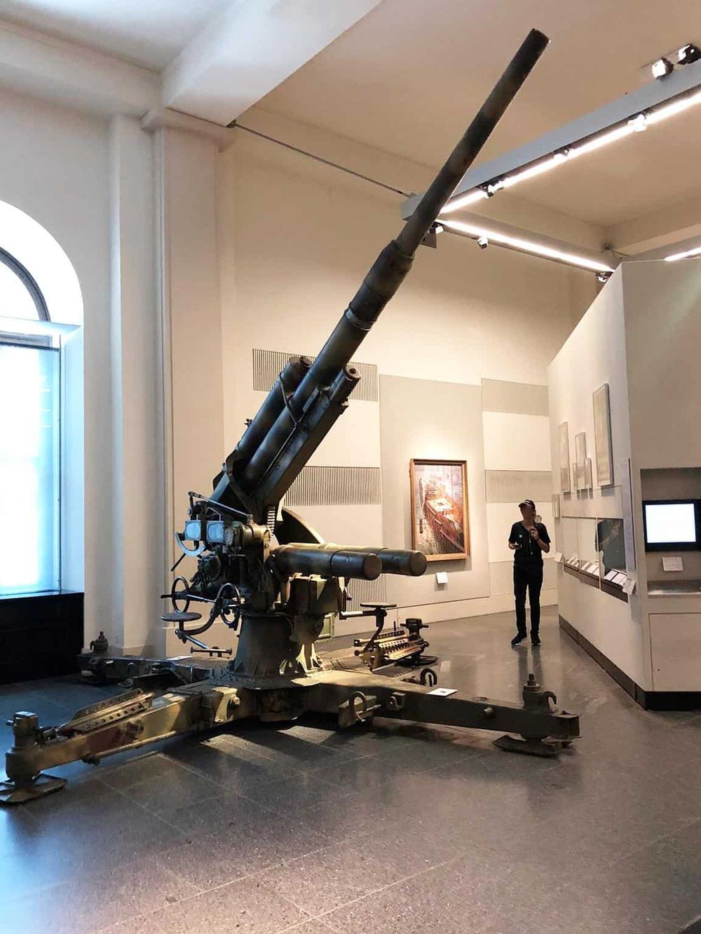 Large military artillery piece on display at Quest for Directions museum, showcasing historical weaponry and artillery technology.