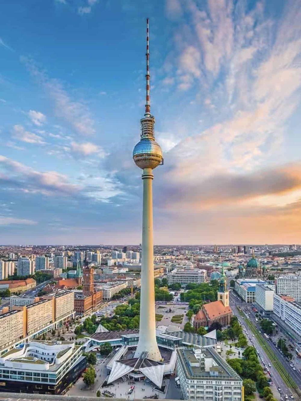 Iconic Berlin TV Tower with city skyline and sunset view for tourism and travel enthusiasts.