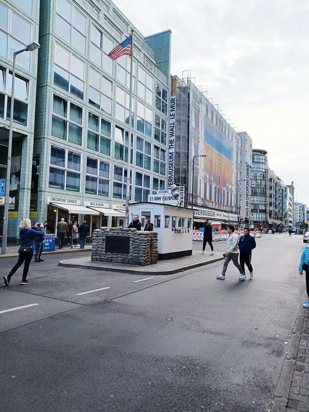 Crowds gather outside the U.S. Navy Memorial and Museum in Washington, D.C., showcasing a vibrant urban setting.