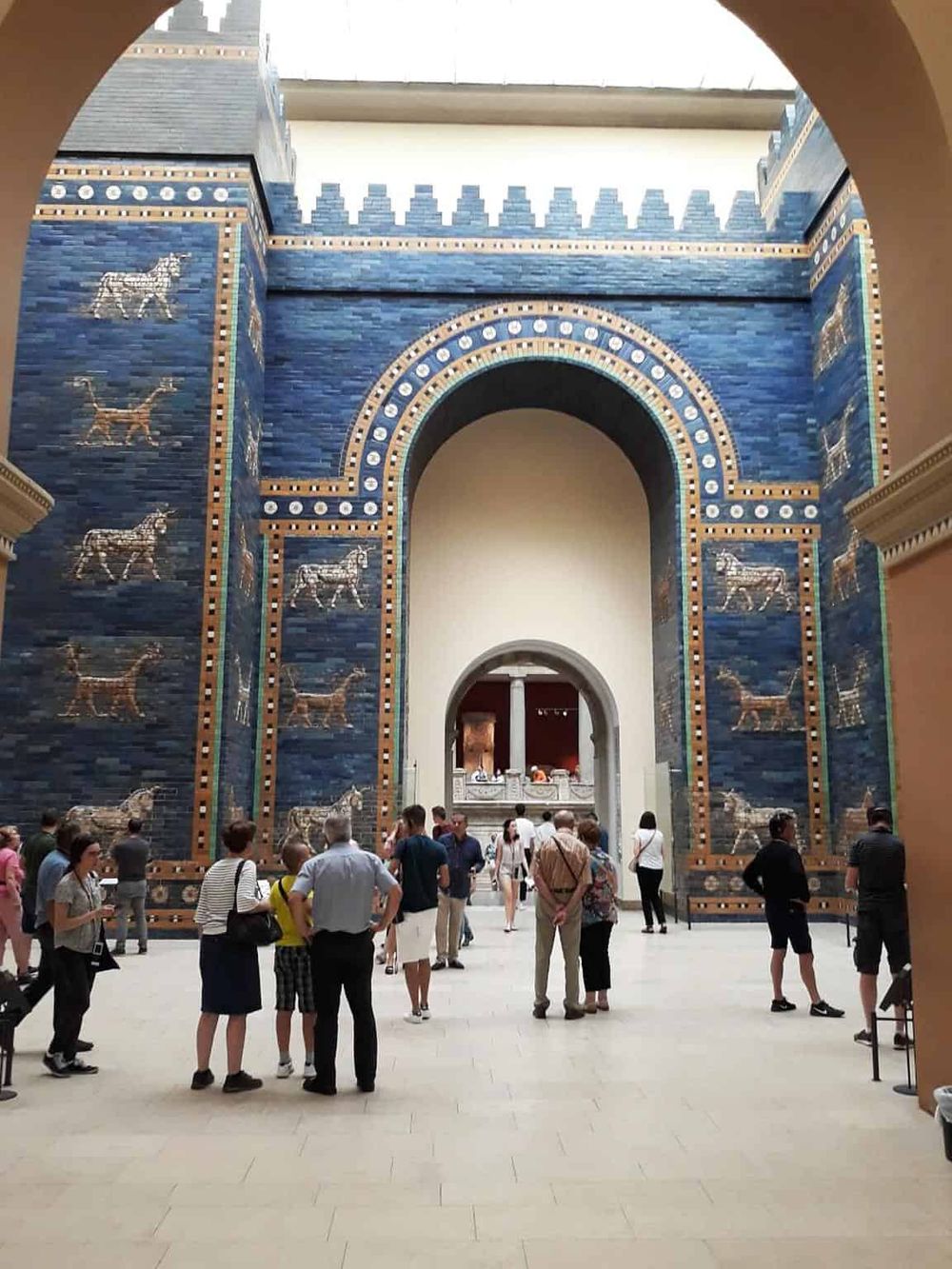 Ancient Mesopotamian-inspired architecture at the Pergamon Museum with visitors exploring the exhibits.