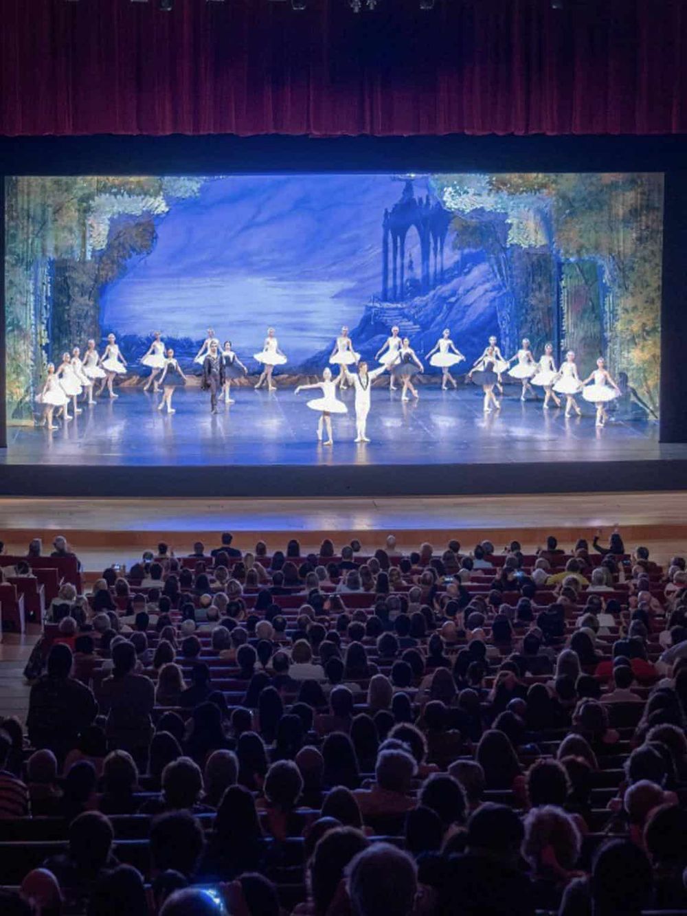 Young ballet dancers performing on stage during a dance recital or performance.